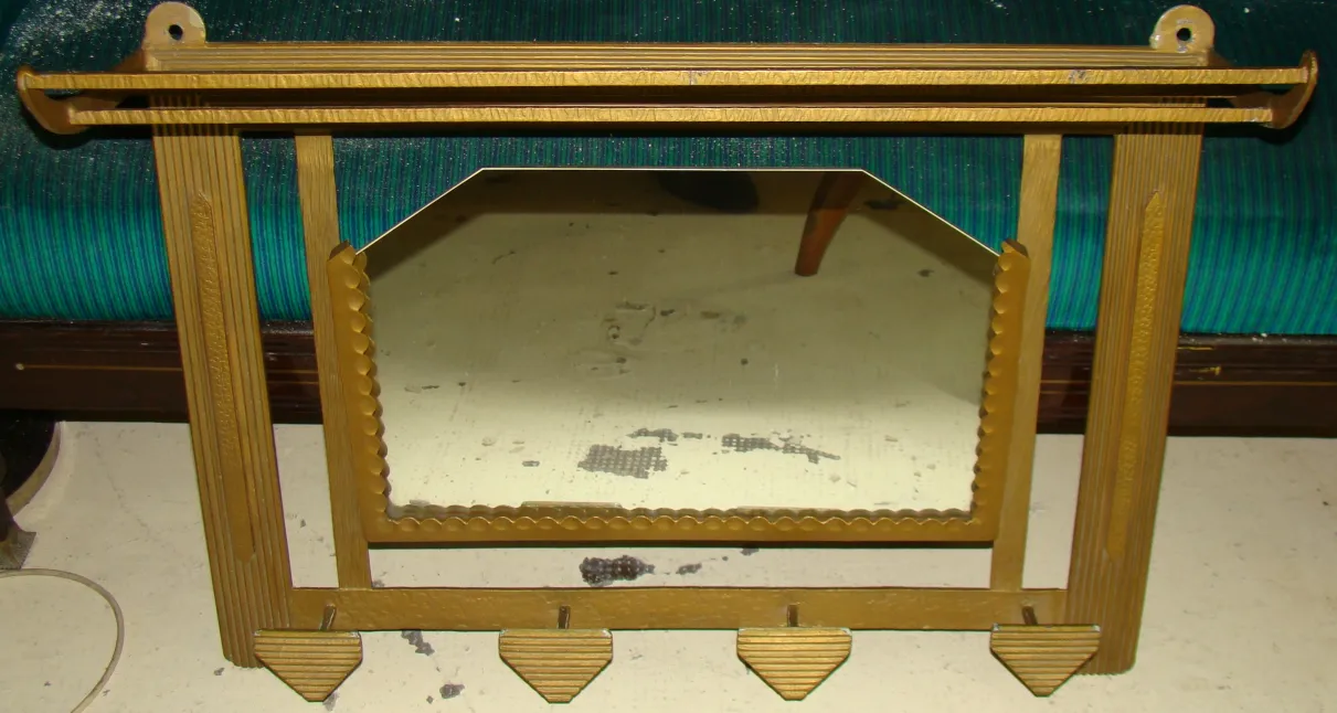 Antique coat rack with a mirror in a simple setting