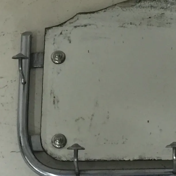 Antique Art Deco mirror with metallic frame.