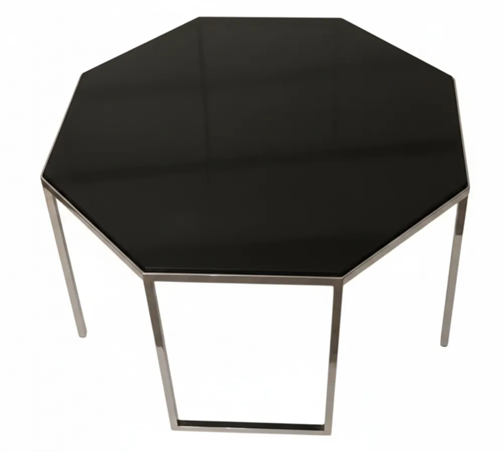 Mesa ratona octagonal antigua en negro con patas de metal en ambiente elegante