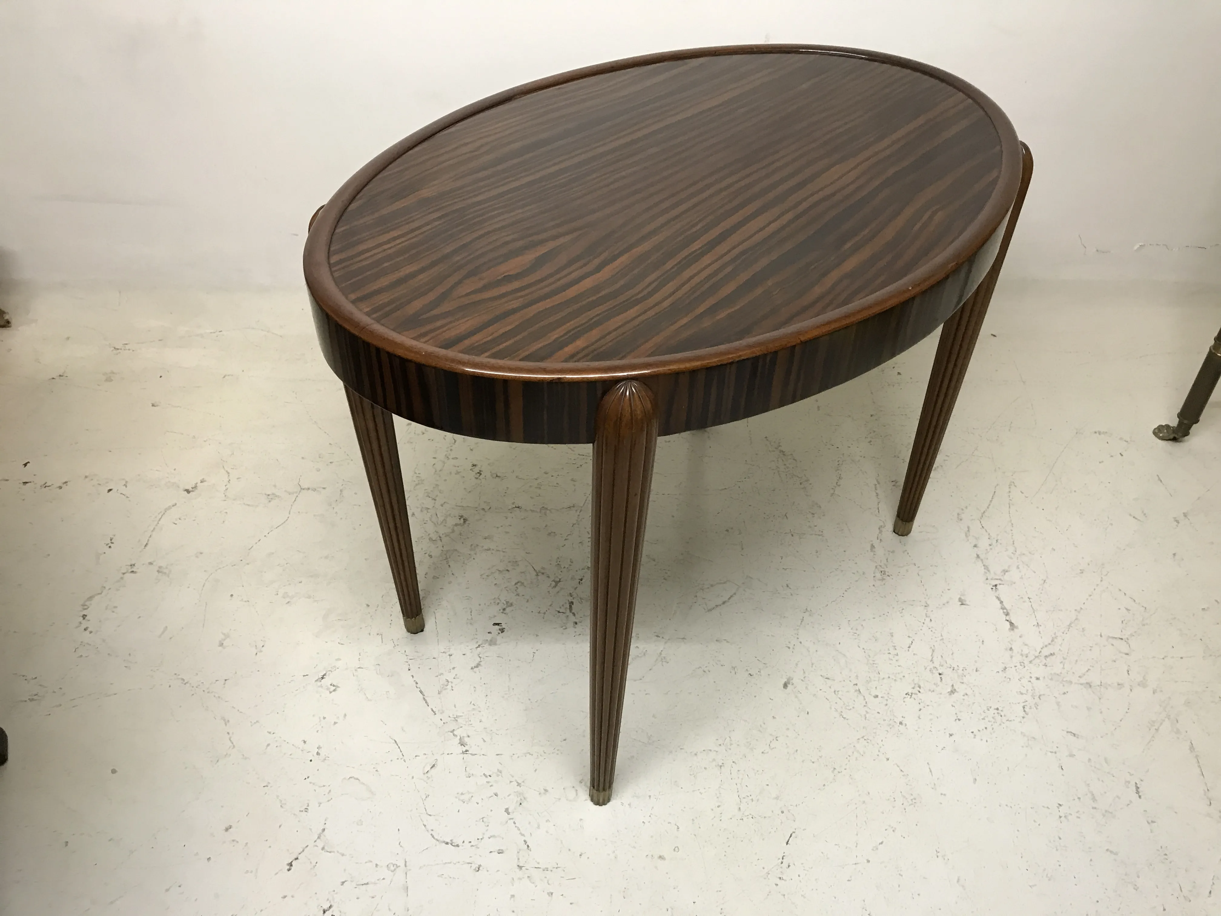 antique oval small table with slender legs in light setting