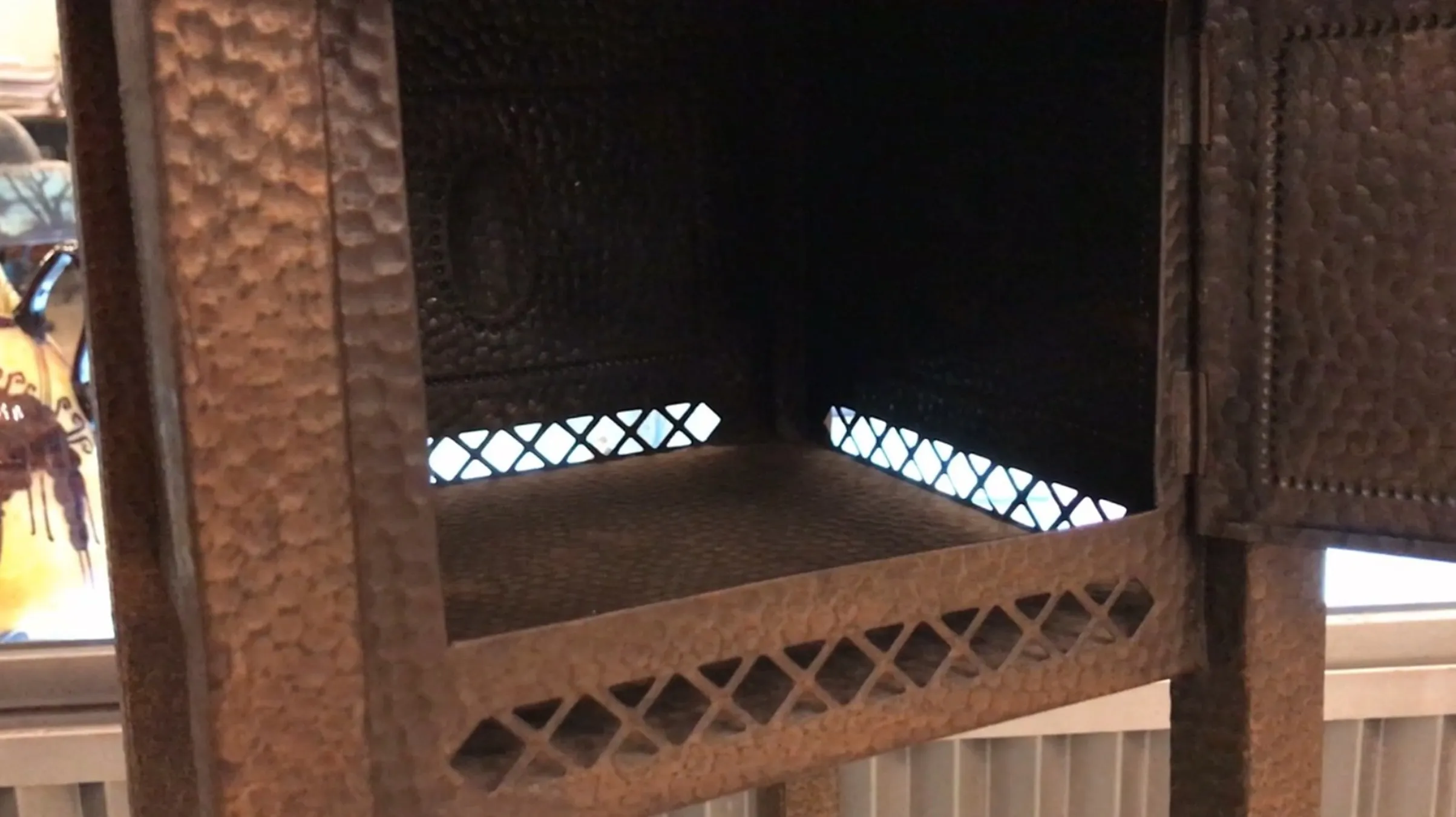 Tavolino antico con design decorativo e spazio interno.