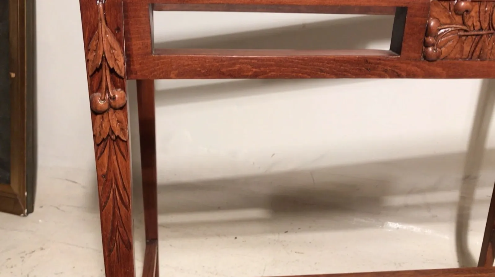 antique table with flower carvings on the legs