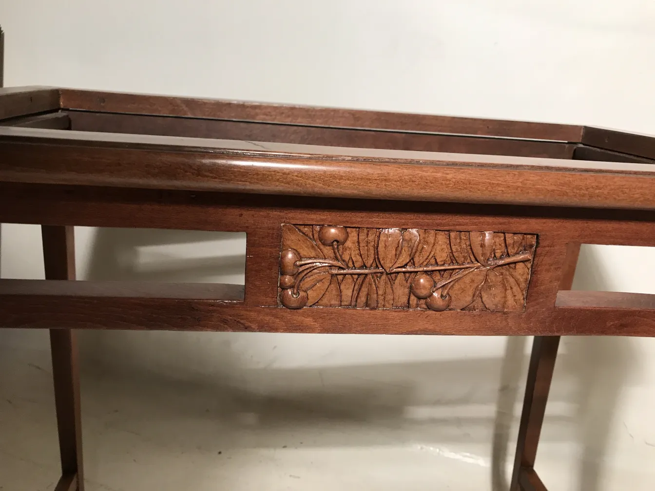 antique table featuring decorative carvings in the center