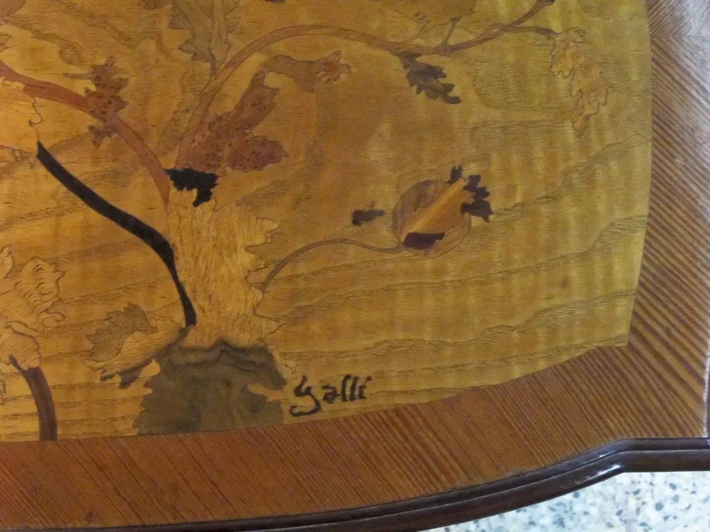 antique table by émile gallé with delicate decorative motifs