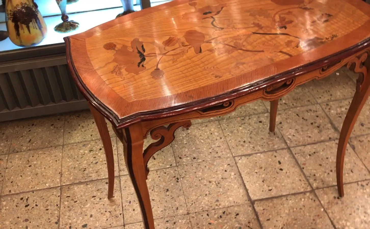 Antique table with Emile Gallé decorative designs.