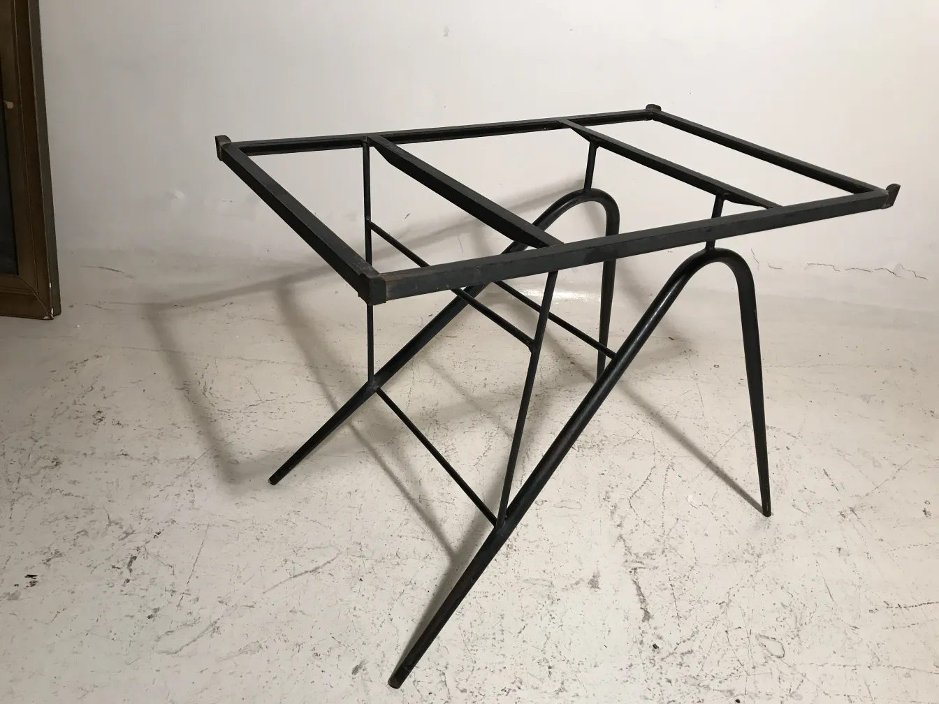 antique garden table with visible structure in a neutral setting