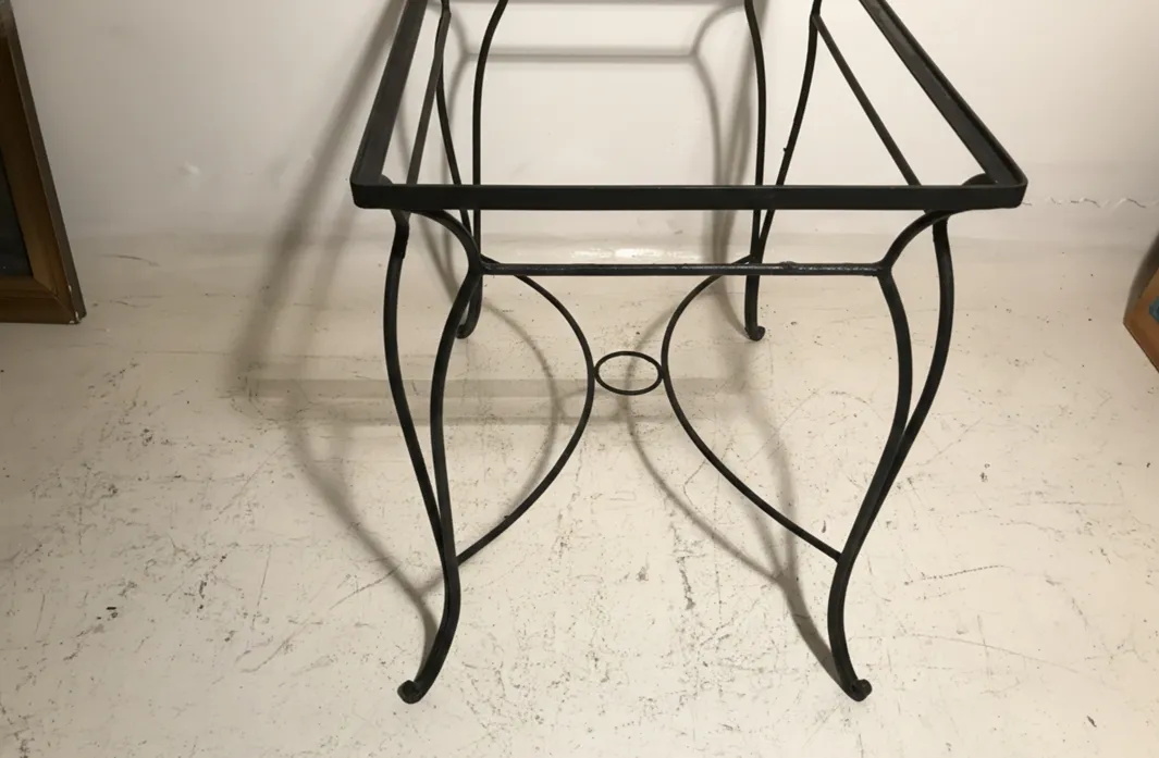 antique garden table with curved legs and elegant design, light background