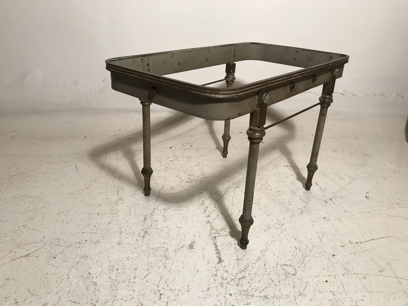 antique garden table with decorative legs and rectangular shape