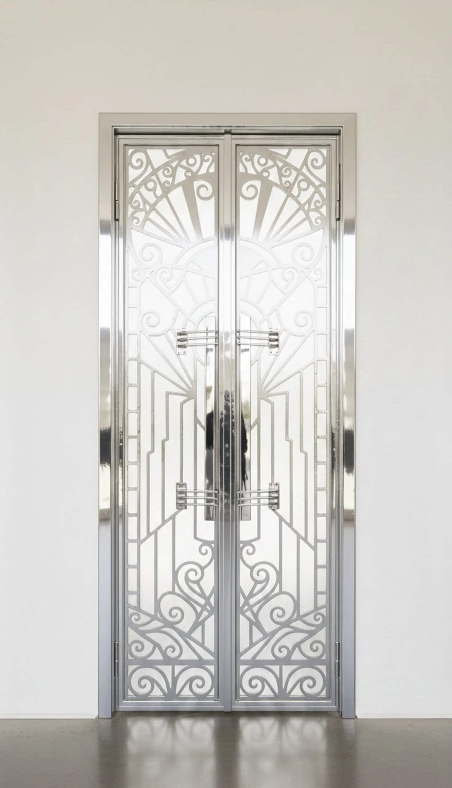 Antique door handles with intricate designs in a modern setting.