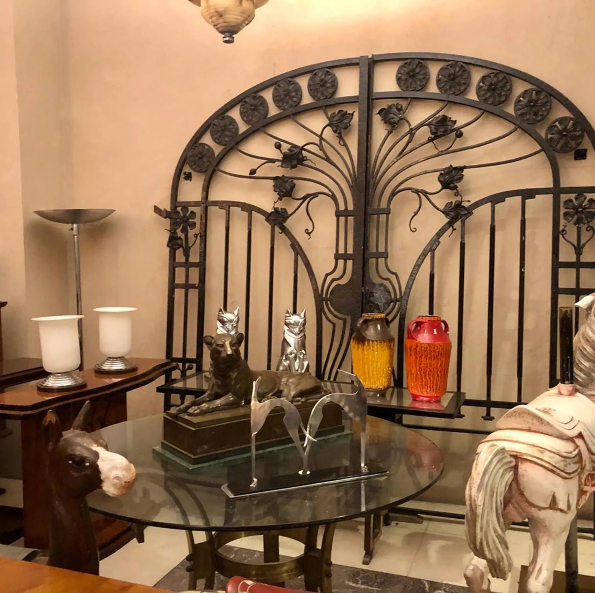 Antique ornamental gate with floral designs and intricate details in a cozy setting.