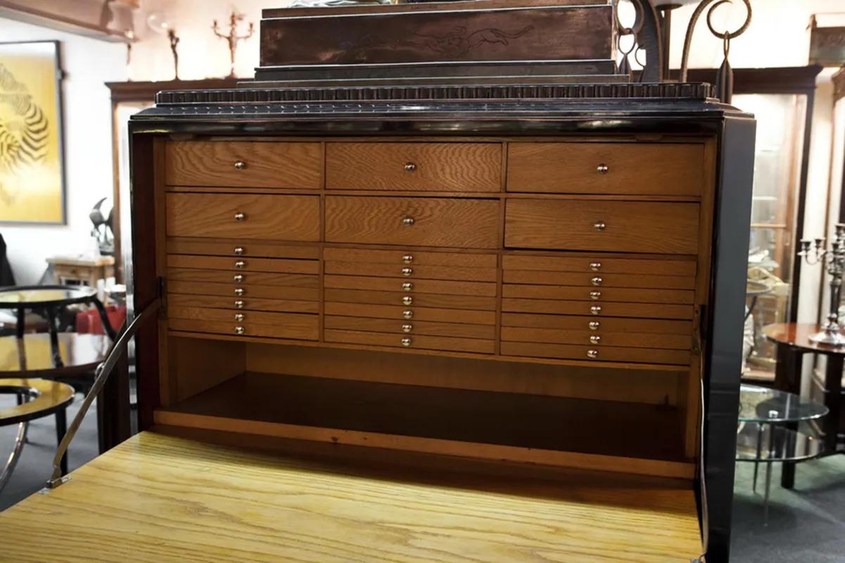 Armário antigo com várias gavetas para armazenar moedas em um ambiente clássico e elegante.