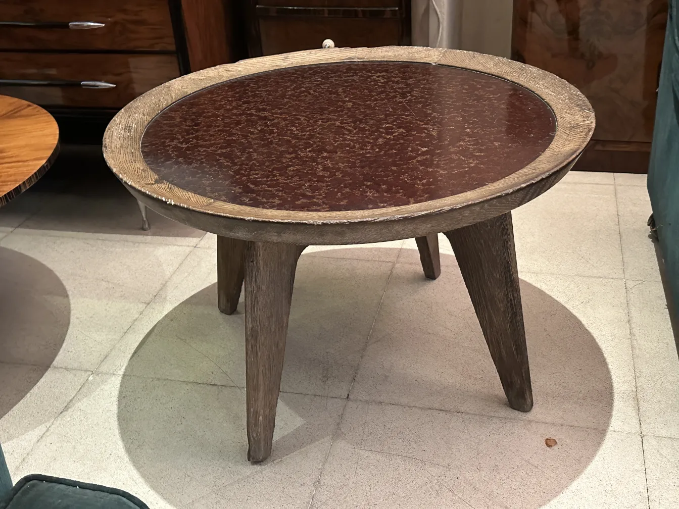 Antique coffee table featuring a distinctive design by Charlotte Perriand, in a cozy setting.