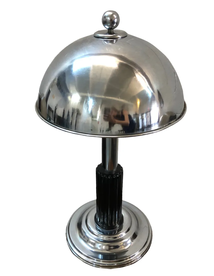 Antique table lamp with a shiny dome design and decorative base in art deco style.