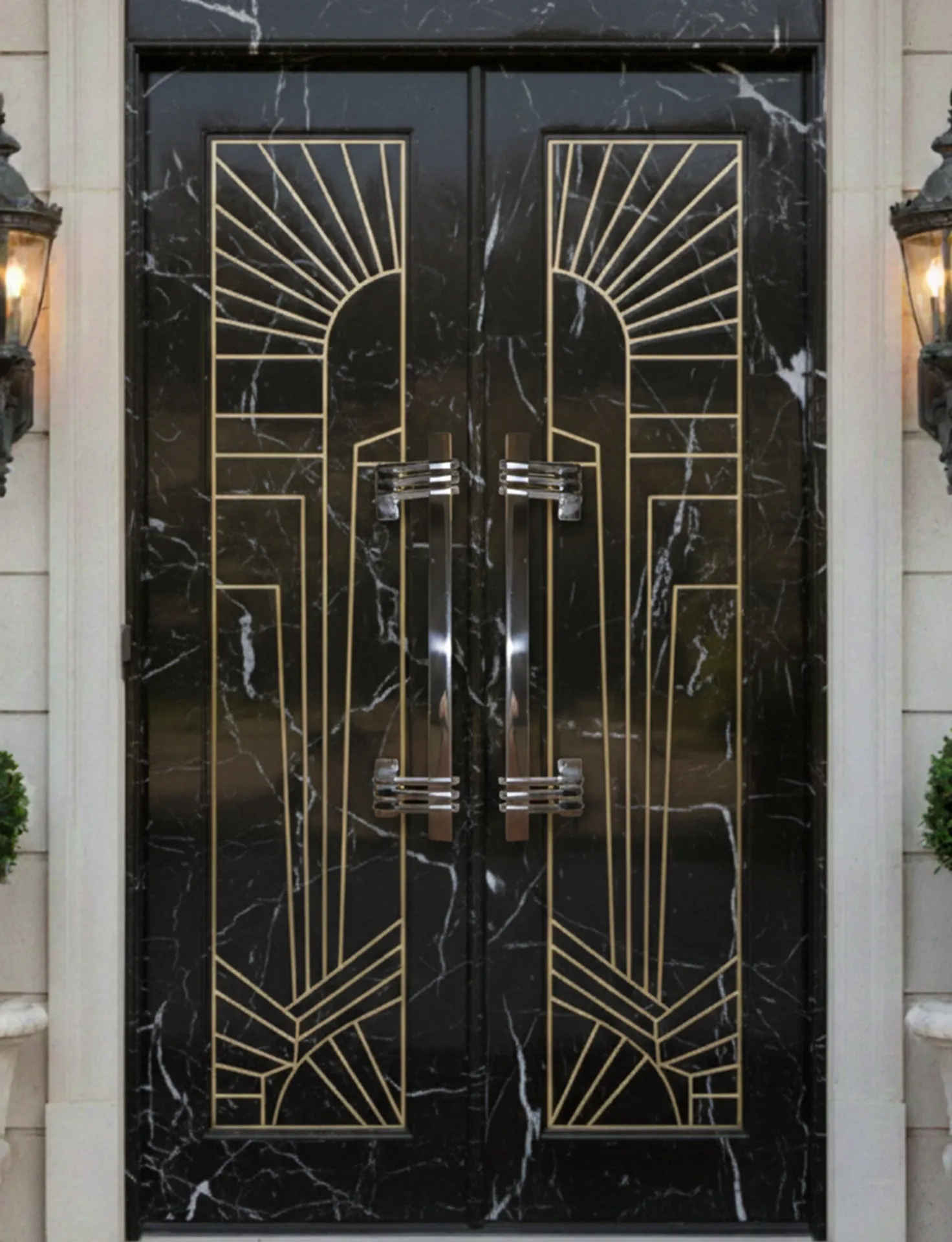 Antique door handles with an elegant design on a black and gold door.