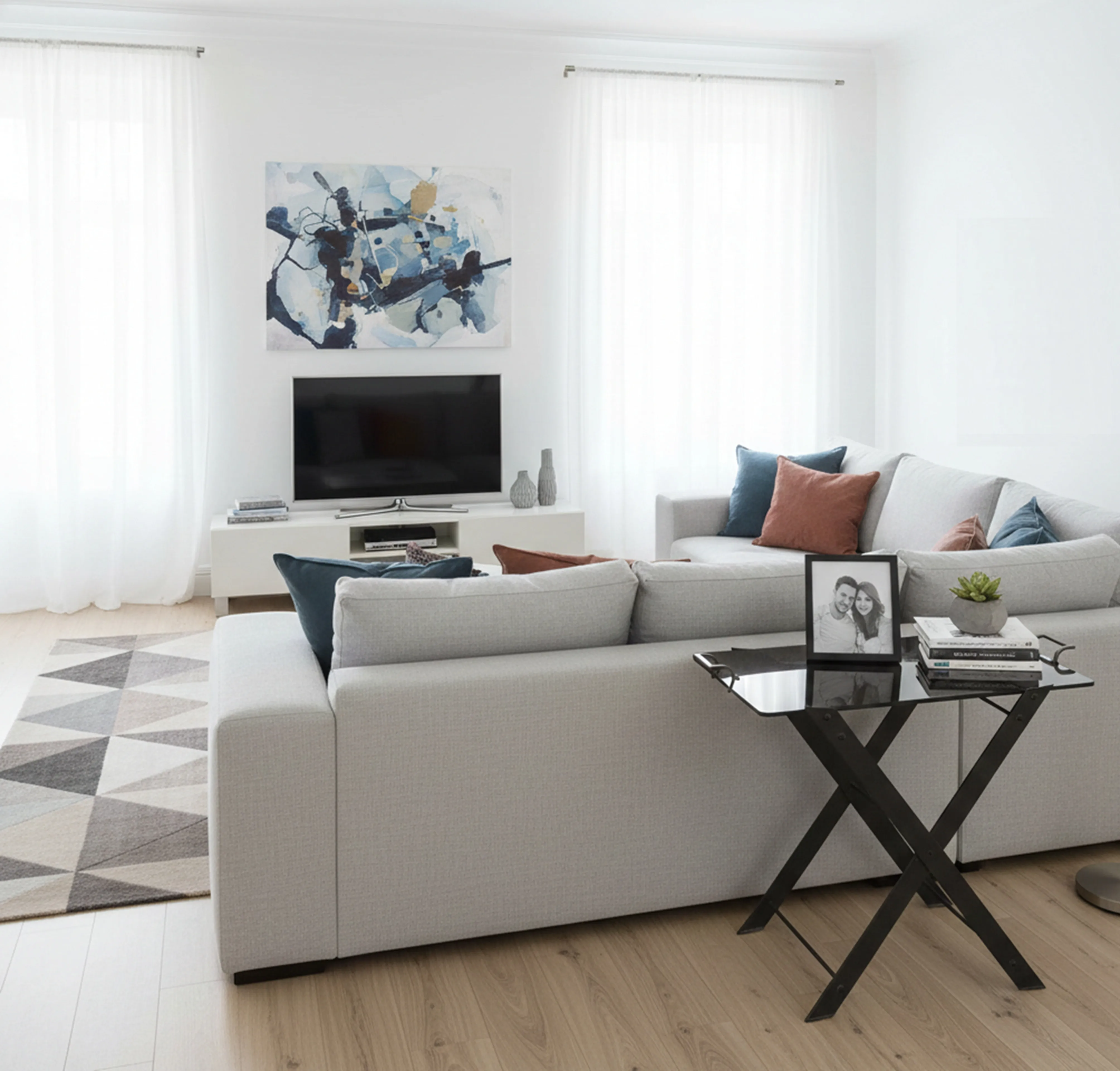 Antique table in a modern living room with soft decor.