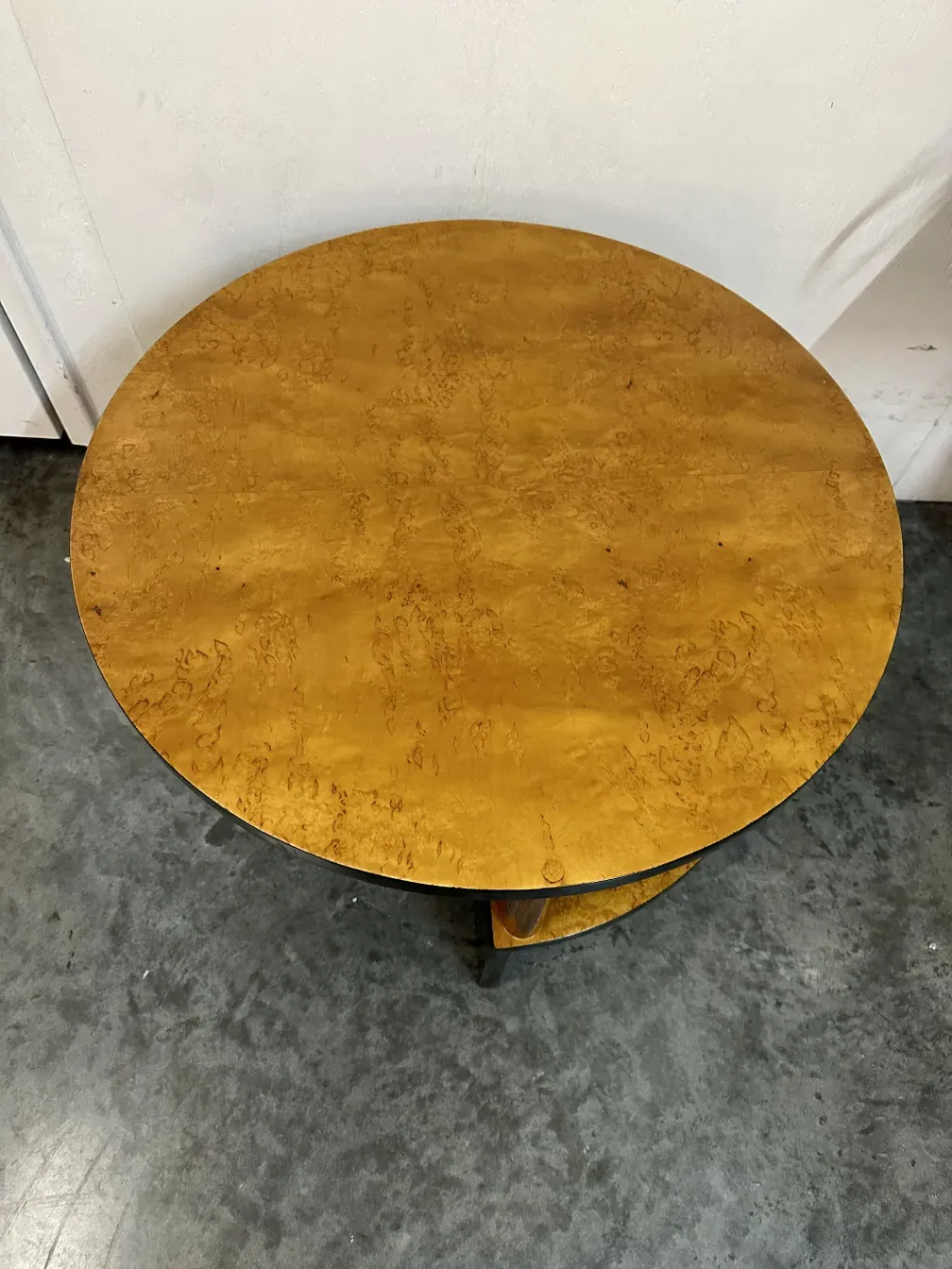 2 antique small tables with a round top in a neutral setting