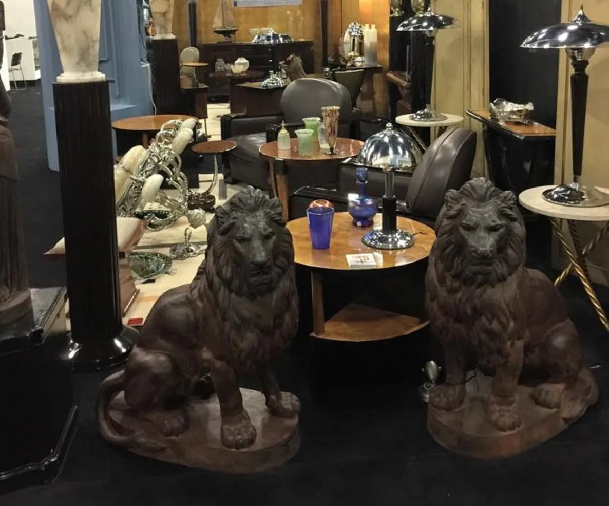 Antique scene with 2 small decorative tables among lions