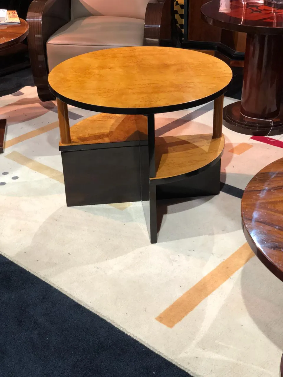 2 antique small tables in circular shape with modern design, placed in an elegant room.