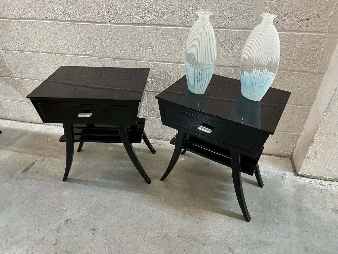 two antique murano vases on black tables