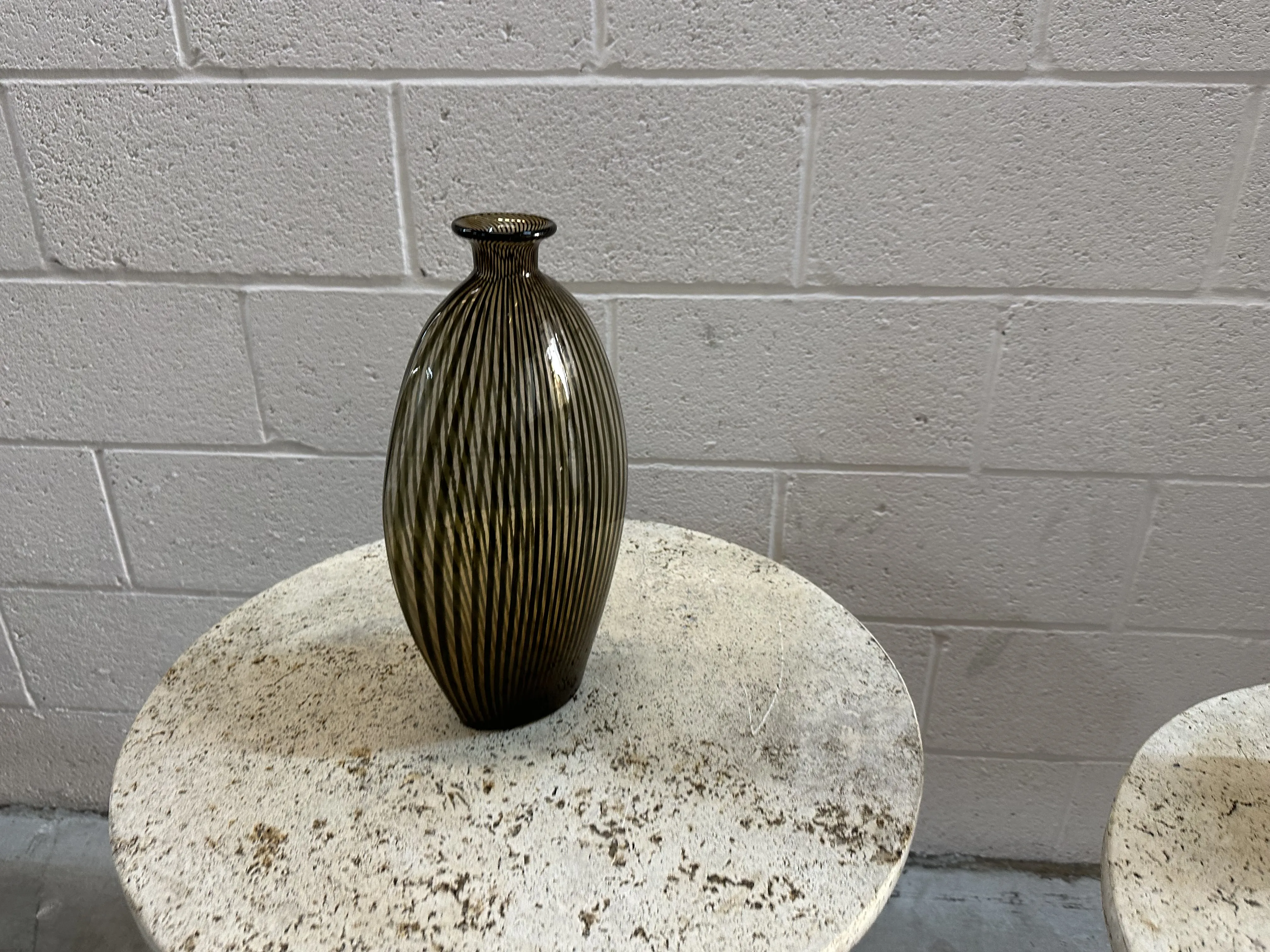 antique murano vase with oval shape and stripes, white background