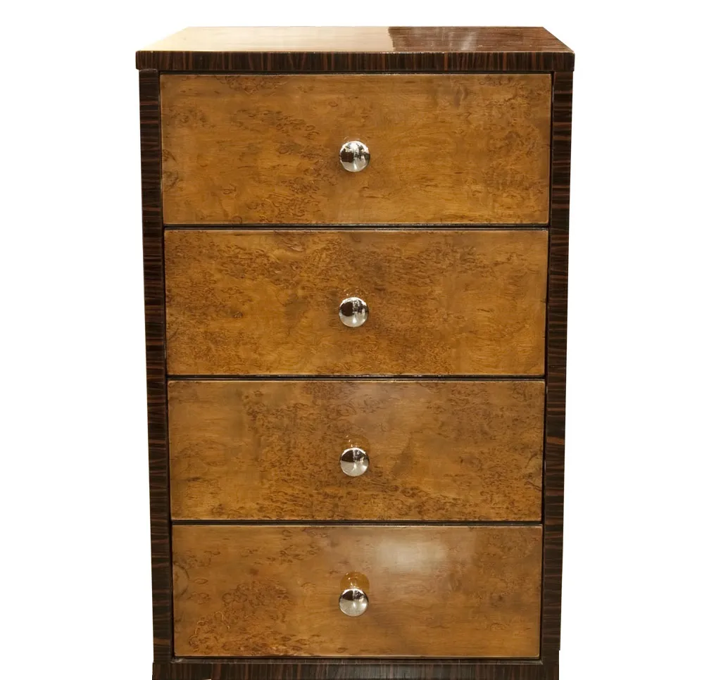 Antique cabinet with a shiny surface and four drawers, in a neutral background.