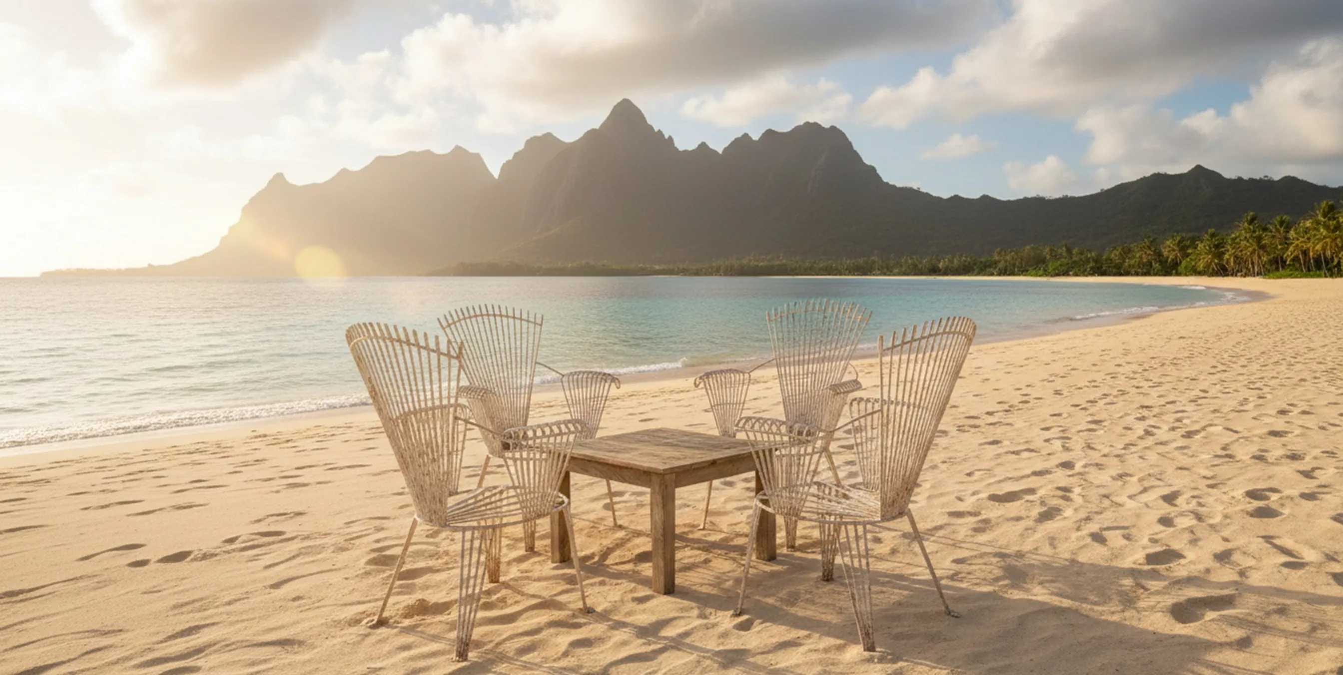 Four antique garden armchairs surrounded by sand and sea