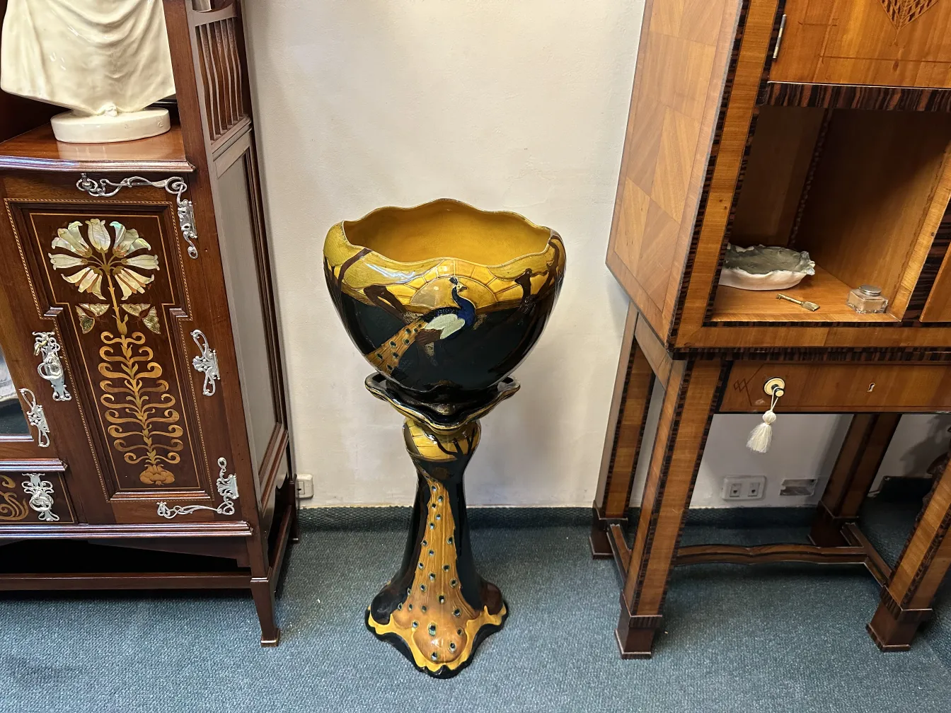 antique standing planter with ornamental details at the base, smooth background