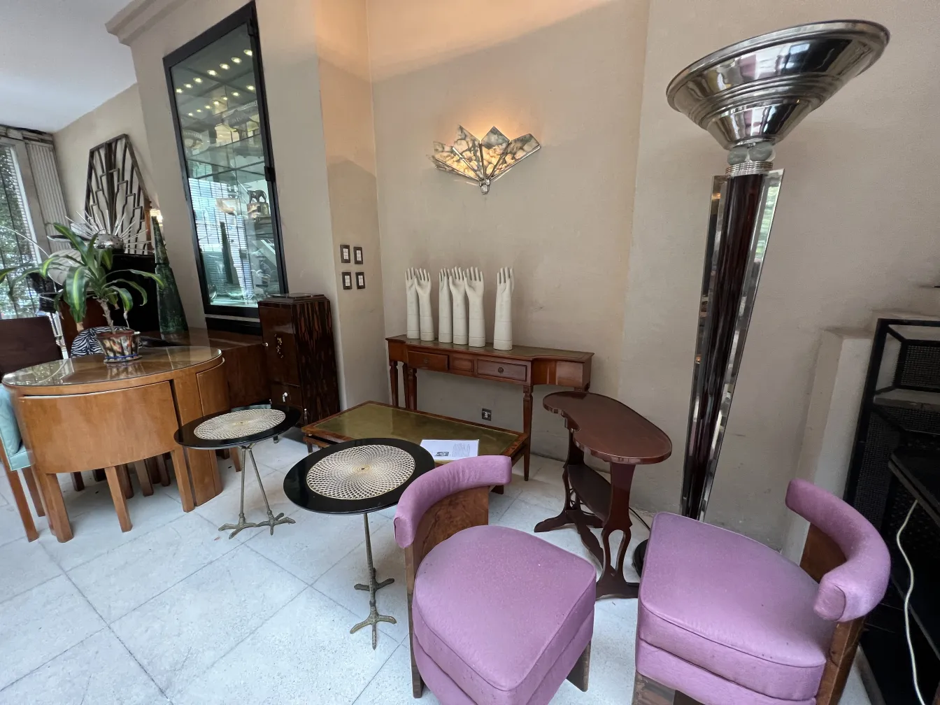 purple antique armchairs in an elegant environment, surrounded by various furniture.