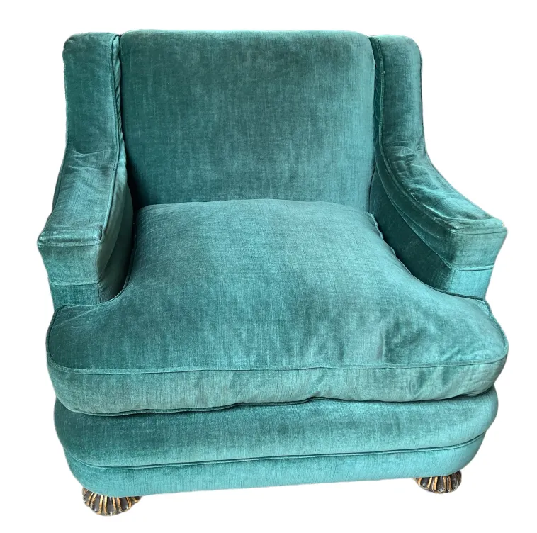 Two antique armchairs in aqua tones ready for restoration, set in a cozy environment.