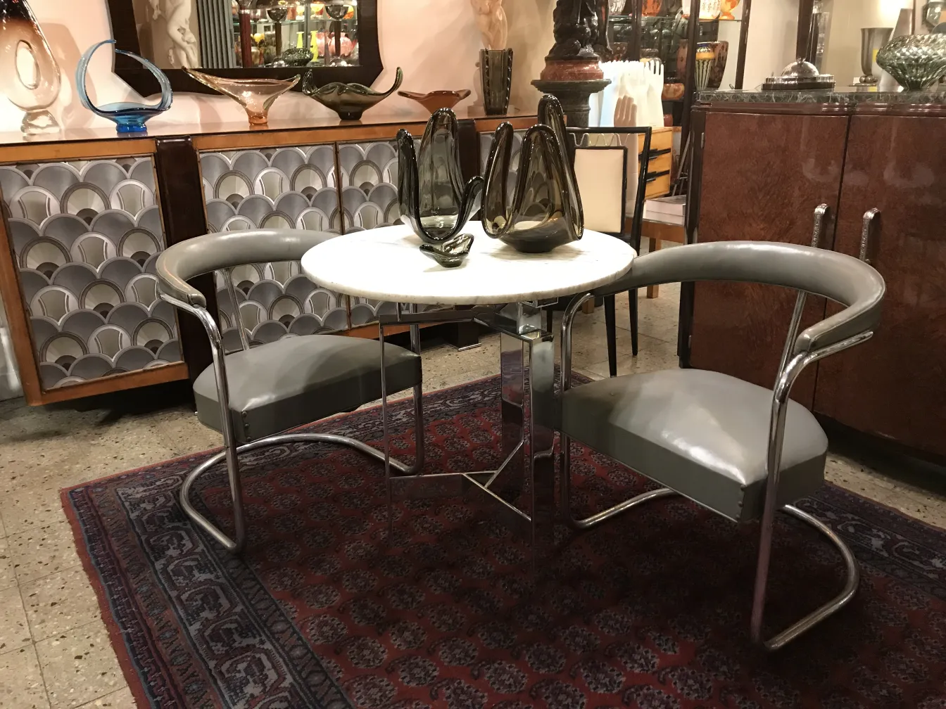 Two unique antique armchairs perfect for restoration, surrounded by elegant decor.