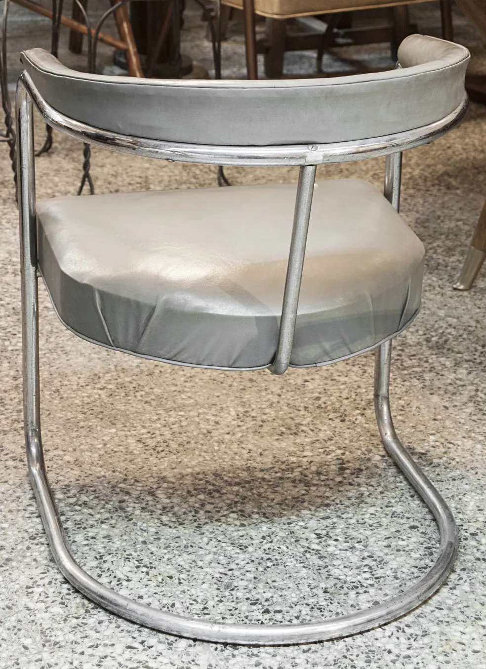 two antique armchairs with visible structure, placed in an antique setting.