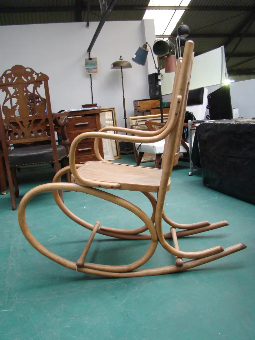 antique hammock chair with curved design in a cozy setting