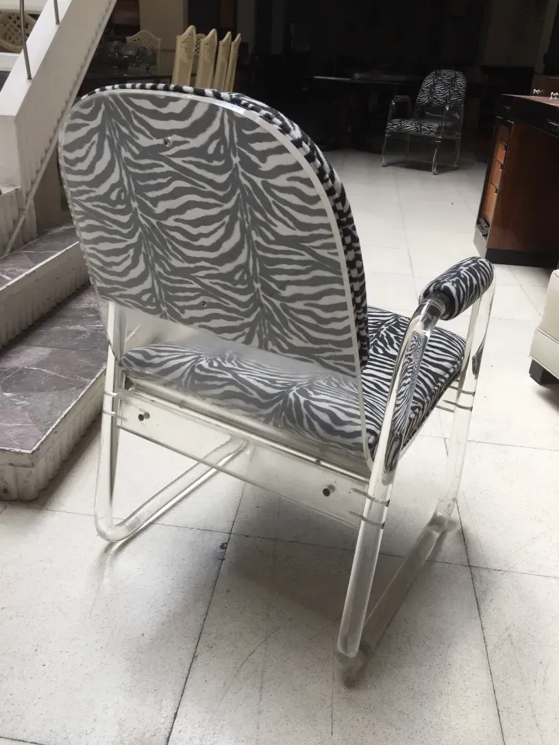 two antique armchairs with black and white zebra design in a classic setting