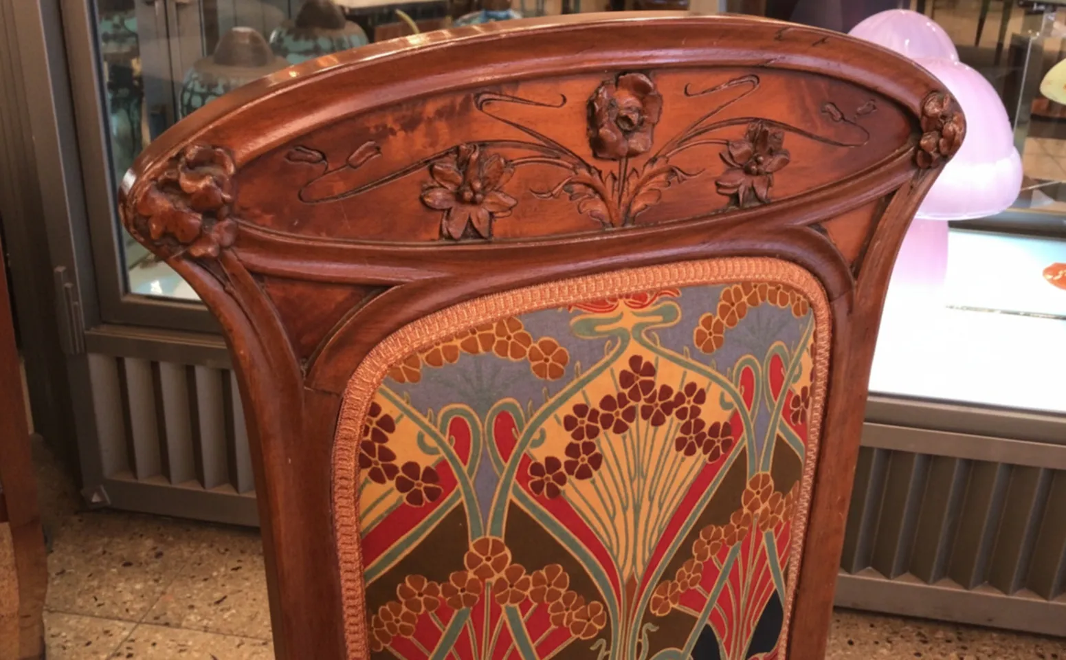 Antique chair in Art Nouveau style with floral details.