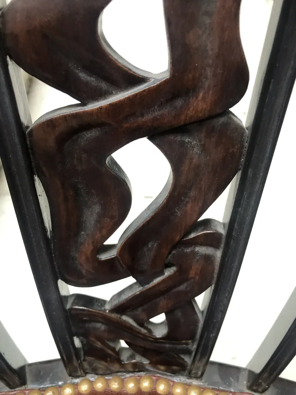 intricate carvings on two unique antique chairs