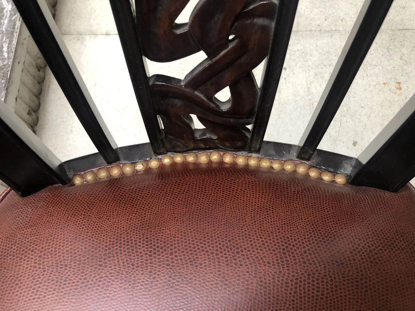 two antique chairs with decorative top