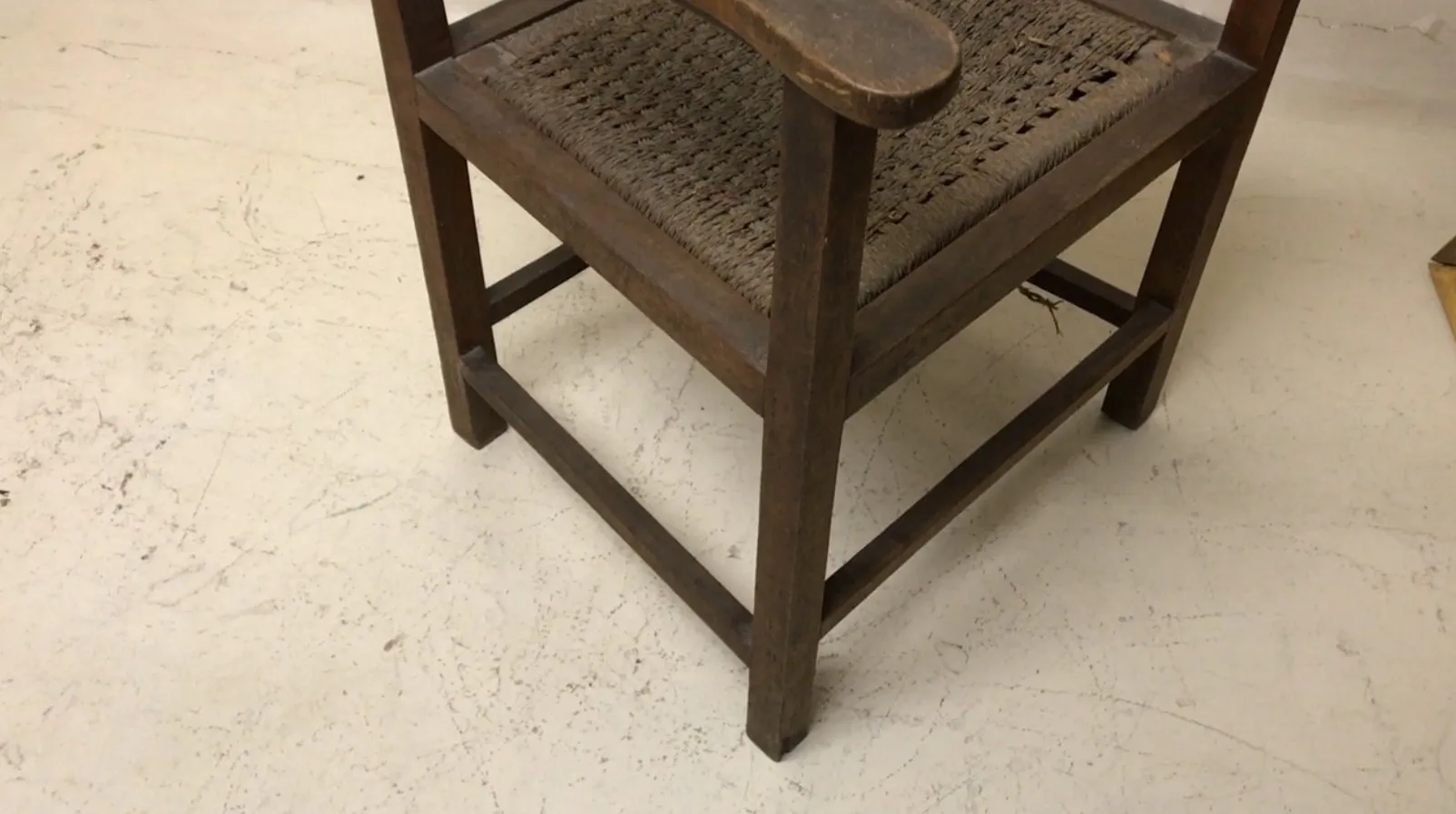 Antique armchair with armrests in a classic setting.