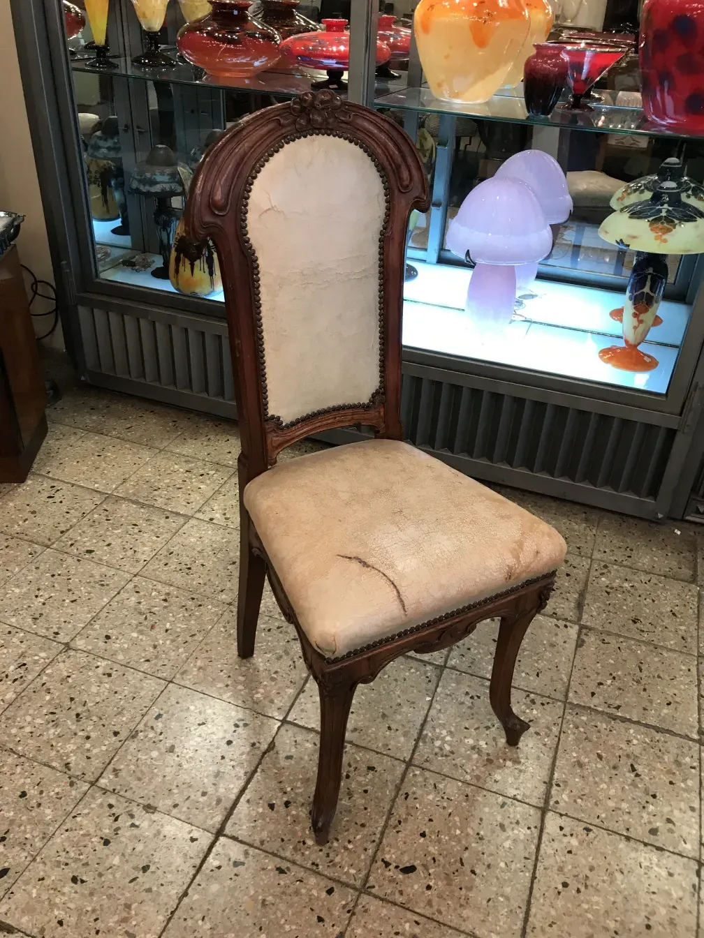 elegant antique chair with worn upholstery, antique environment