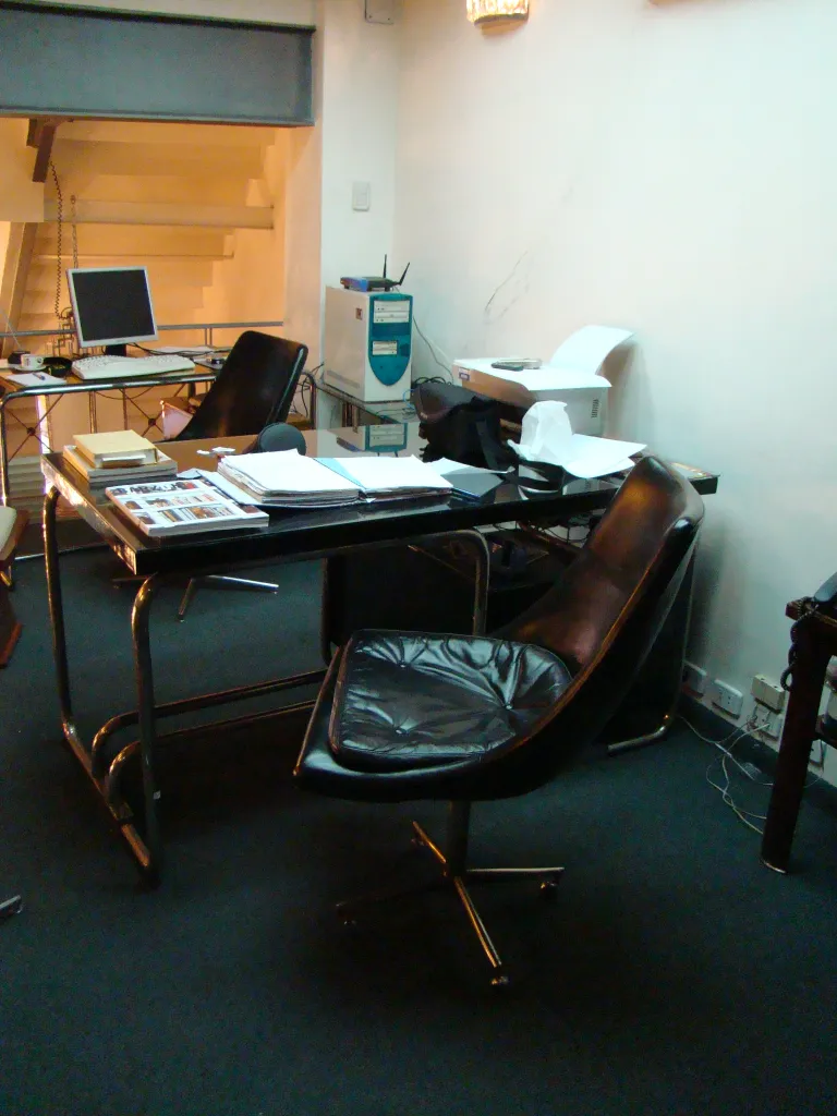 two antique desk chairs in an office setting