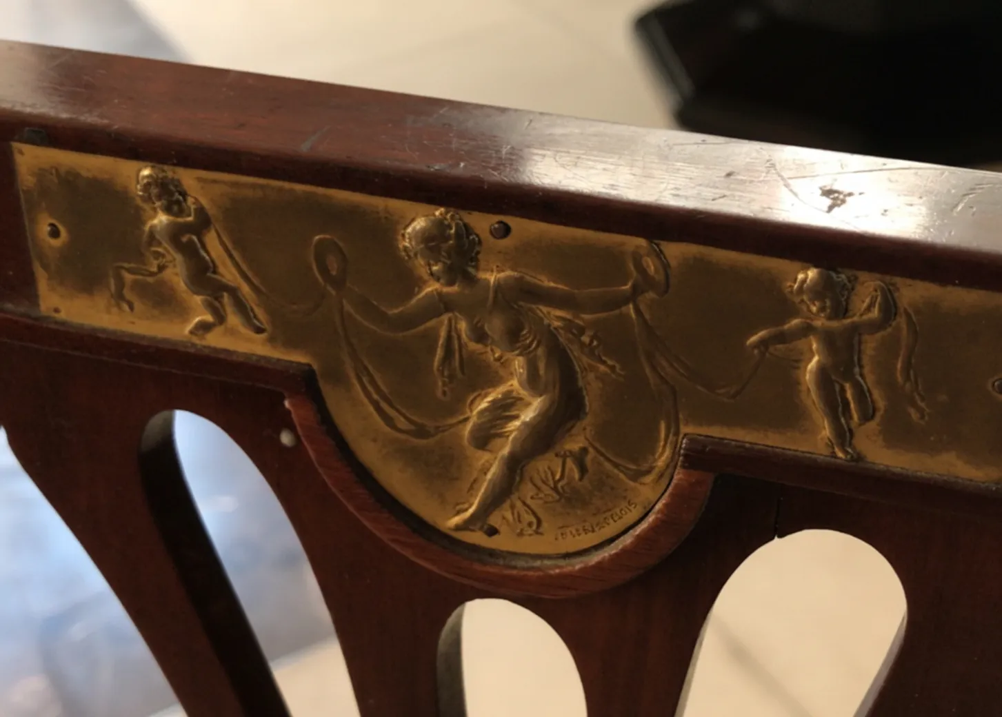 golden details on antique chairs with figures