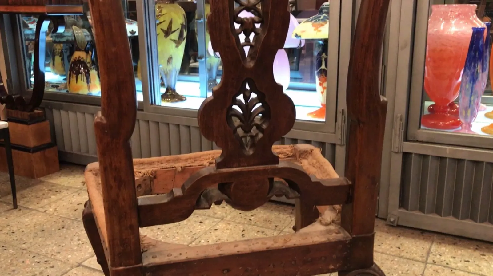 two antique chairs to restore, intricately designed in a warm setting