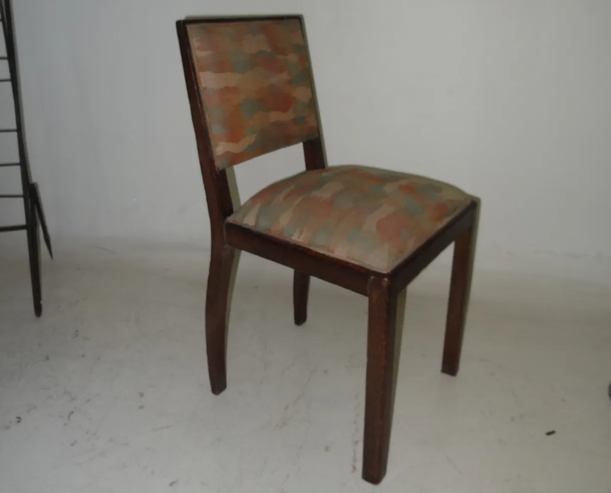 Antique chair with patterned upholstery, neutral setting.