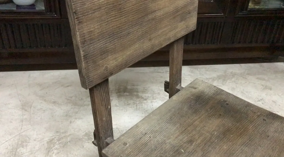 Antique chair by Jean Michel Frank featuring rustic design in a cozy setting.