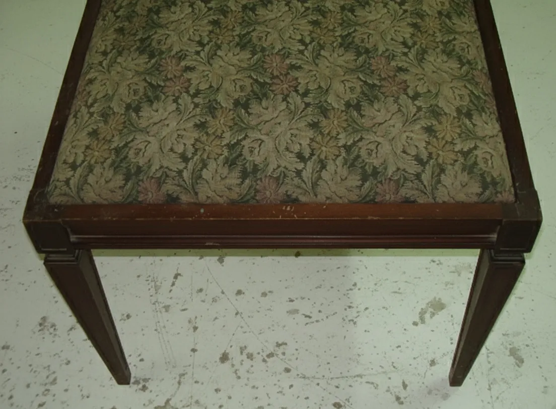 Antique decorative stool with floral upholstery on top