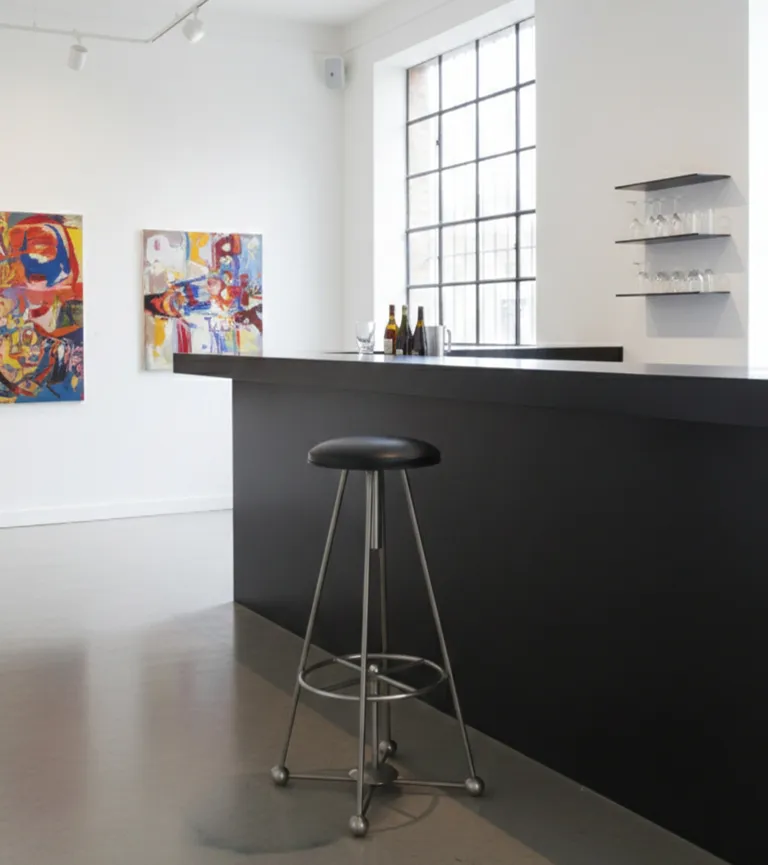 antique bar stool with black seat in modern setting