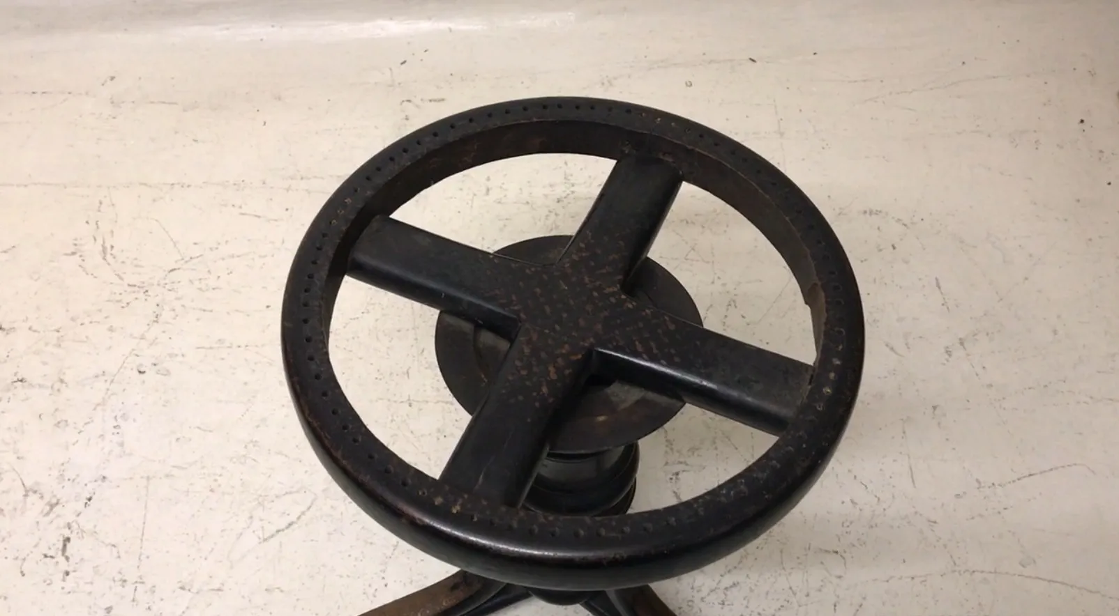 top view of an antique thonet sidewalk stool, perforated pattern, classic design