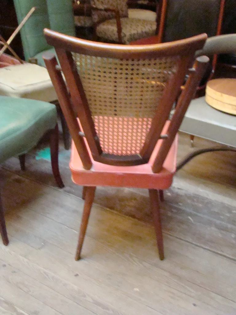 Four antique chairs stacked in a vintage environment