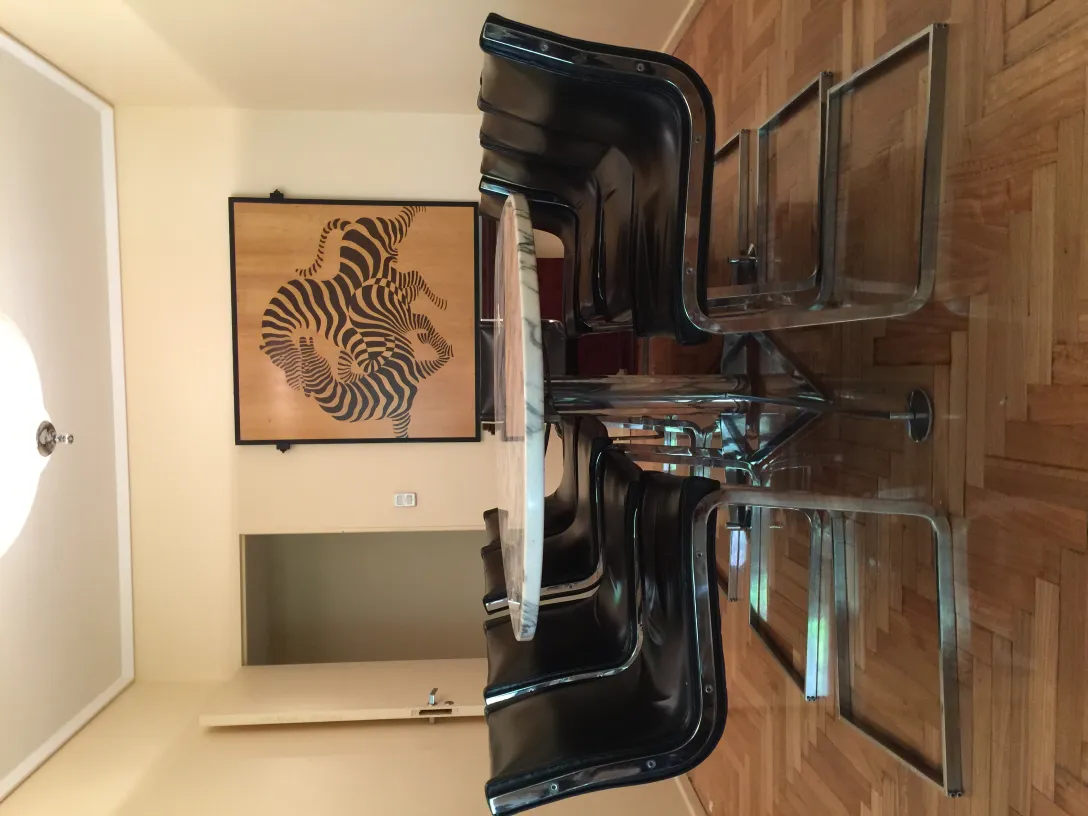 10 antique chairs ready for restoration in a modern setting