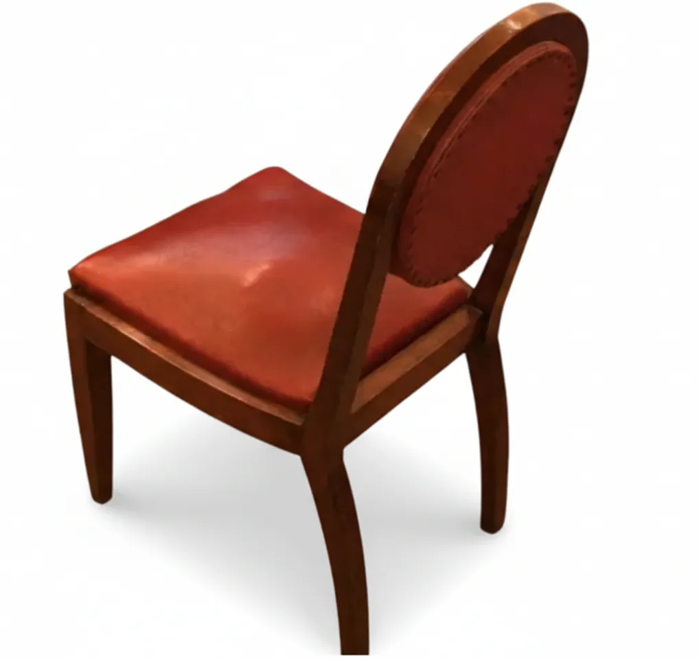 Side view of 12 antique chairs on a white background