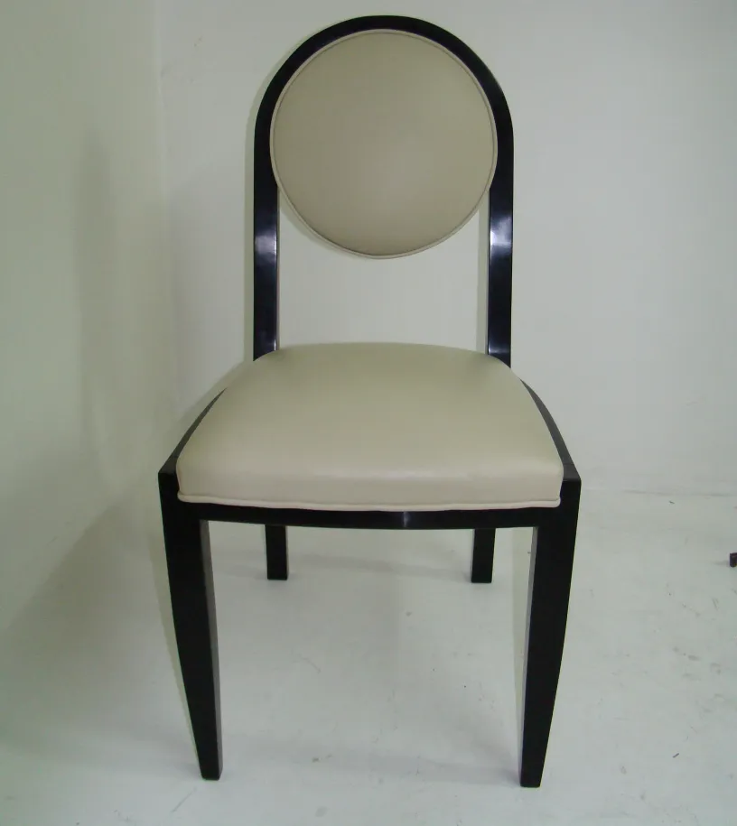 12 antique chairs with round backrest and cushioned seat in a light setting